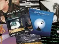 Collage d'albums de David Gilmour et Roger Waters, incluant "Amused to Death" et "On An Island".